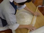 Soba expert shaping dough into a square